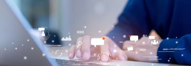 Person typing on a laptop with digital icons representing communication and technology.
